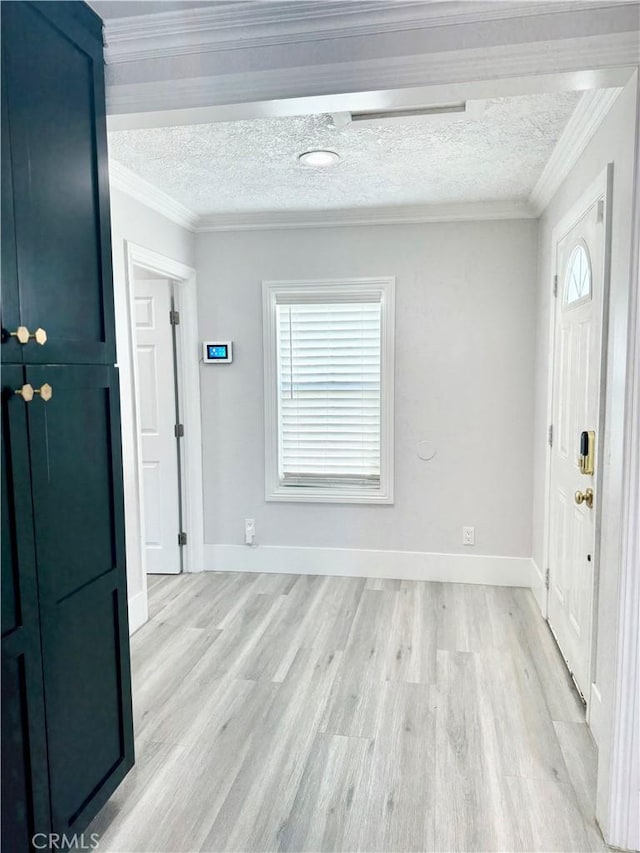 foyer featuring crown molding, light wood finished floors, and a textured ceiling