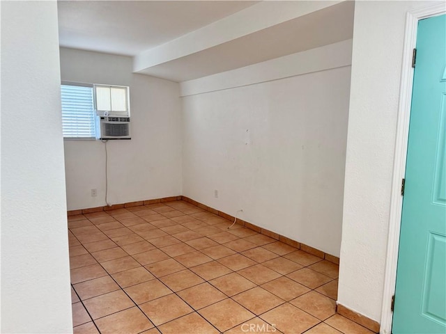 empty room with baseboards and cooling unit