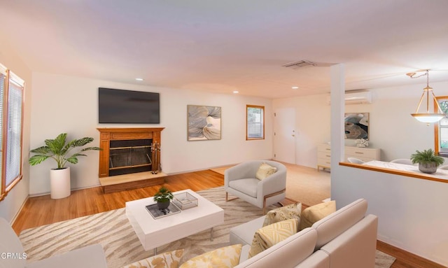 4558 Jessica Dr, Los Angeles, CA 90065 - living area with an AC wall unit, visible vents, a glass covered fireplace, and wood finished floors