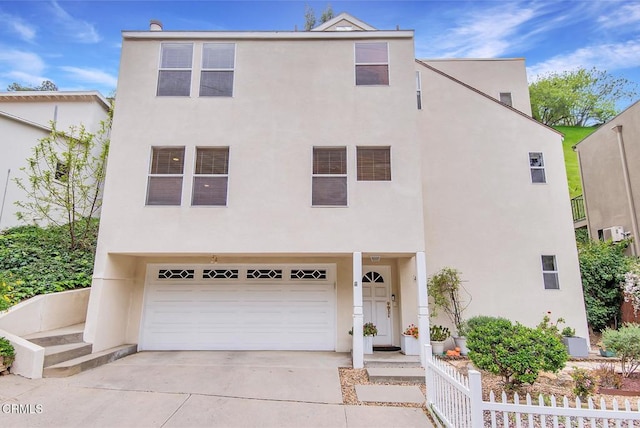 4558 Jessica Dr, Los Angeles, CA 90065 - view of front of house with a garage, fence, stucco siding, and concrete driveway