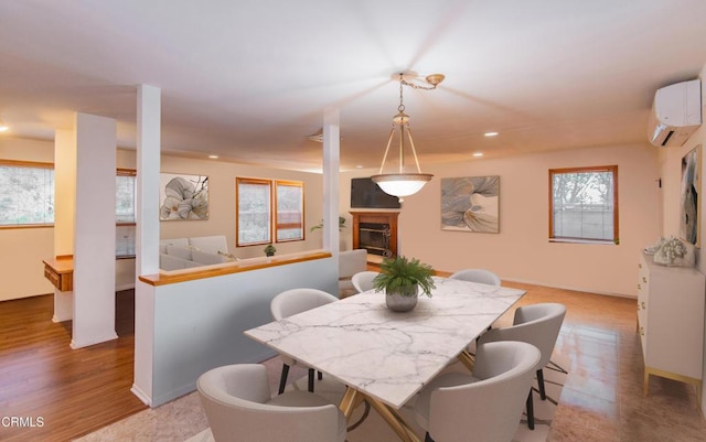 4558 Jessica Dr, Los Angeles, CA 90065 - dining room featuring a wall unit AC, light wood-type flooring, baseboards, a glass covered fireplace, and recessed lighting
