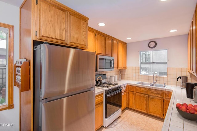 4558 Jessica Dr, Los Angeles, CA 90065 - kitchen featuring a sink, tile counters, stainless steel appliances, and a wealth of natural light
