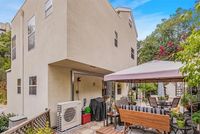 4558 Jessica Dr, Los Angeles, CA 90065 - rear view of house with outdoor dining space, a gazebo, ac unit, stucco siding, and a patio area