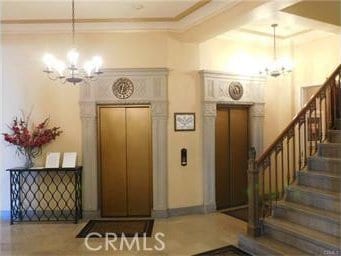 800 E Ocean Blvd Unit 1404, Long Beach, CA 90802 - foyer entrance featuring a chandelier, elevator, ornamental molding, and stairway