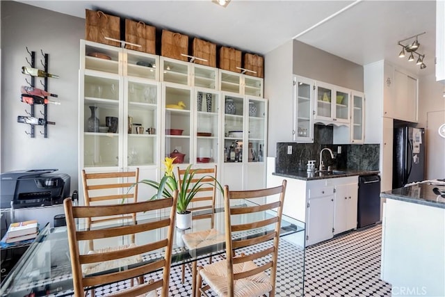 800 E Ocean Blvd Unit 1404, Long Beach, CA 90802 - kitchen with black appliances, white cabinetry, tasteful backsplash, glass insert cabinets, and dark stone countertops
