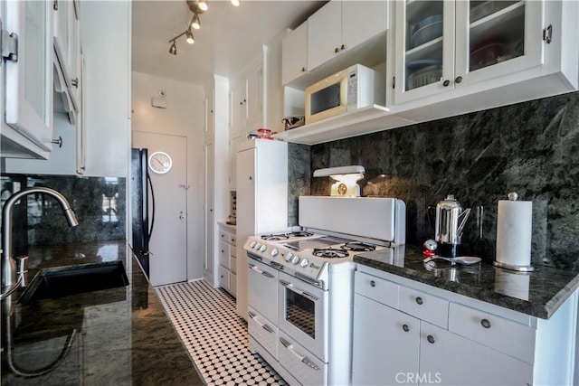 800 E Ocean Blvd Unit 1404, Long Beach, CA 90802 - kitchen featuring white appliances, decorative backsplash, white cabinets, glass insert cabinets, and dark stone countertops