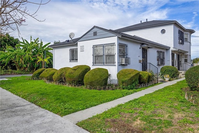 view of side of home with a lawn and stucco siding