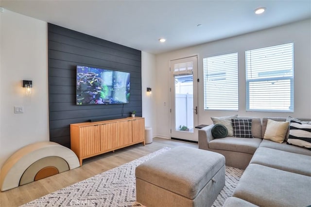 24307 Juni Ct, Corona, CA 92883 - living room featuring radiator heating unit, light wood-type flooring, recessed lighting, wooden walls, and baseboards