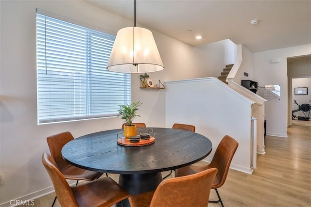 24307 Juni Ct, Corona, CA 92883 - dining space with baseboards, light wood finished floors, and stairway