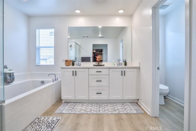 24307 Juni Ct, Corona, CA 92883 - bathroom with double vanity, toilet, wood finished floors, a bath, and a shower stall