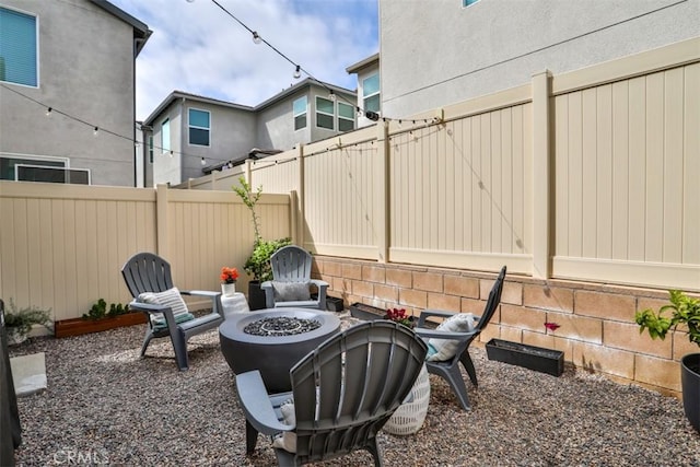 view of patio featuring a fire pit and a fenced backyard