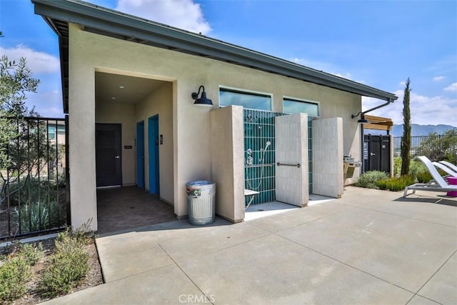 exterior space with a patio, stucco siding, and fence