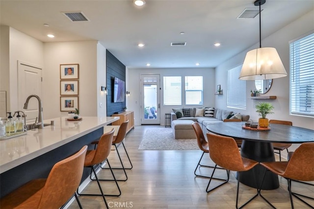 dining area with visible vents, light wood-type flooring, and recessed lighting