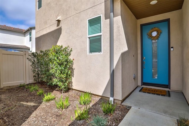 view of exterior entry featuring stucco siding