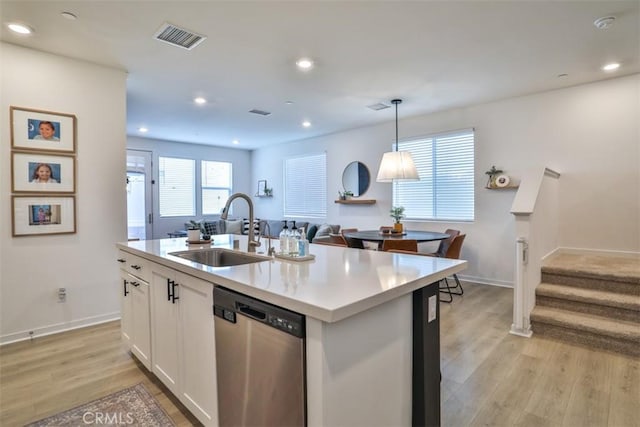 24307 Juni Ct, Corona, CA 92883 - kitchen featuring stainless steel dishwasher, a sink, light wood-type flooring, light countertops, and white cabinetry