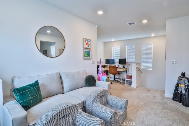 carpeted living area featuring visible vents and recessed lighting