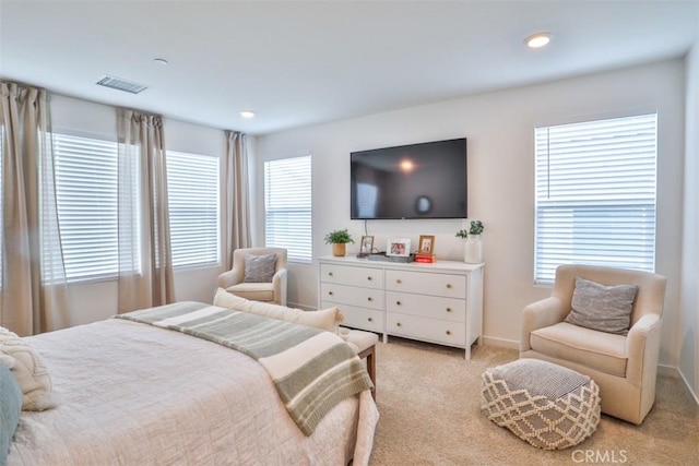 bedroom featuring visible vents, light carpet, multiple windows, and recessed lighting