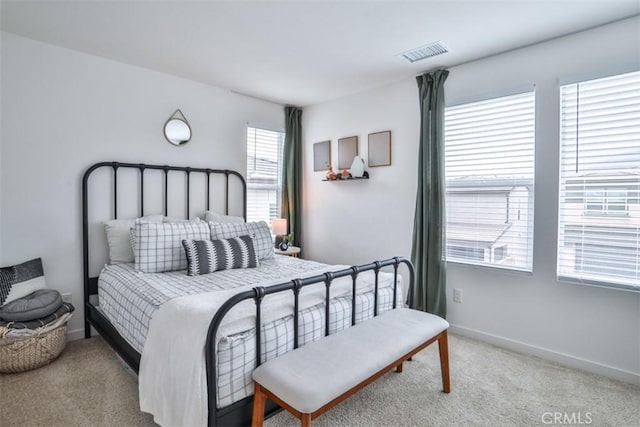 bedroom with light carpet, baseboards, and visible vents