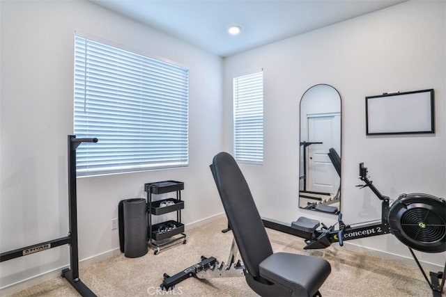 exercise area featuring carpet flooring and baseboards