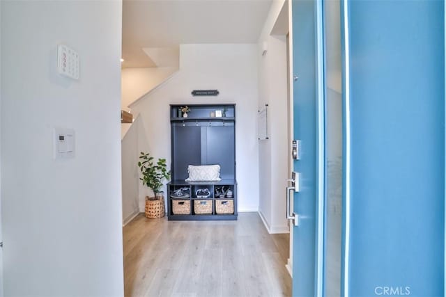 foyer entrance with wood finished floors and baseboards