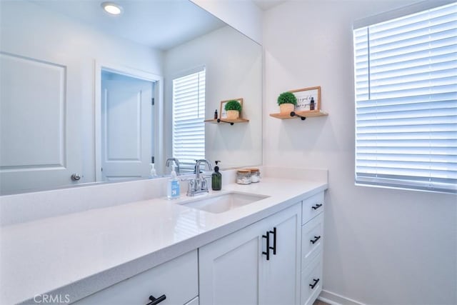 bathroom featuring baseboards and vanity