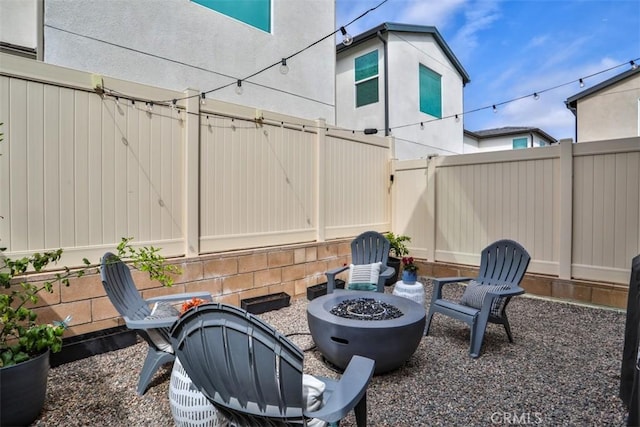 view of patio / terrace featuring fence and a fire pit