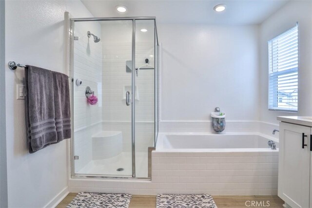 24307 Juni Ct, Corona, CA 92883 - bathroom featuring a bath, a shower stall, vanity, and recessed lighting