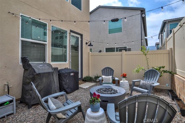 view of patio / terrace with fence and an outdoor fire pit