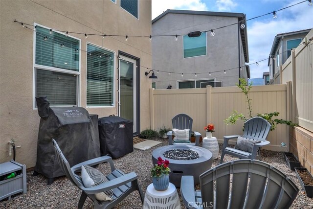 24307 Juni Ct, Corona, CA 92883 - view of patio featuring an outdoor fire pit