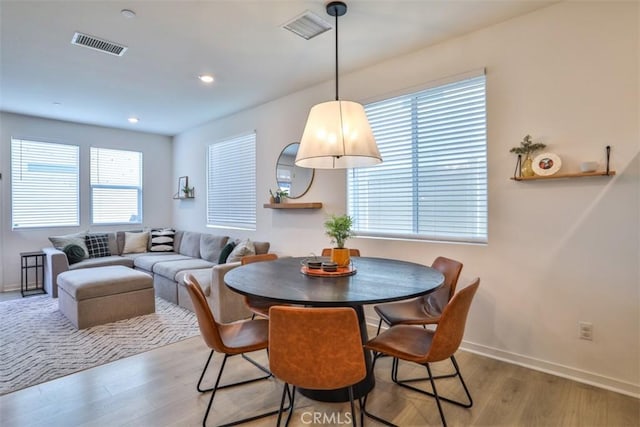 dining space featuring baseboards, visible vents, light wood-style floors, and recessed lighting