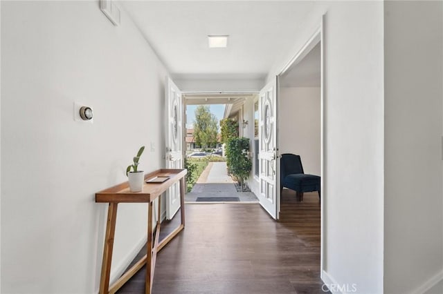 interior space with baseboards, visible vents, and dark wood-style floors