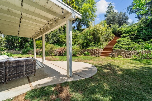 view of yard featuring stairs and a patio area