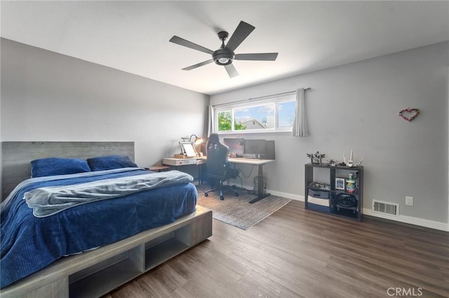 bedroom with visible vents, baseboards, ceiling fan, and wood finished floors