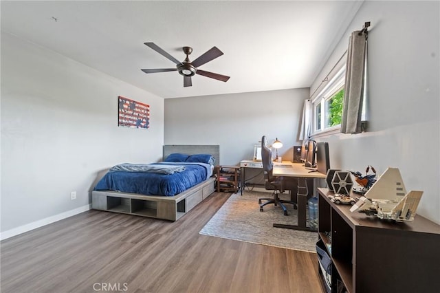 bedroom with baseboards, ceiling fan, and wood finished floors