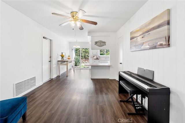 sitting room with baseboards, ceiling fan, dark wood finished floors, and visible vents
