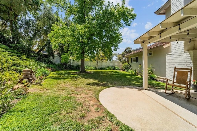 view of yard featuring a patio area and fence