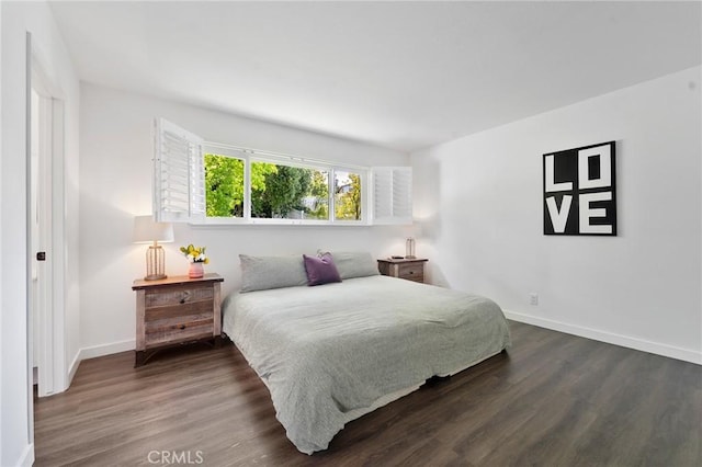 bedroom featuring baseboards and wood finished floors