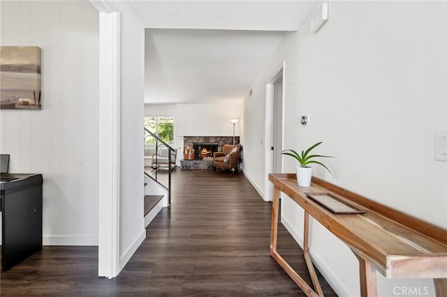 hall with baseboards, wood finished floors, and stairway