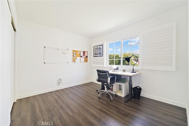 office space with baseboards and dark wood-type flooring