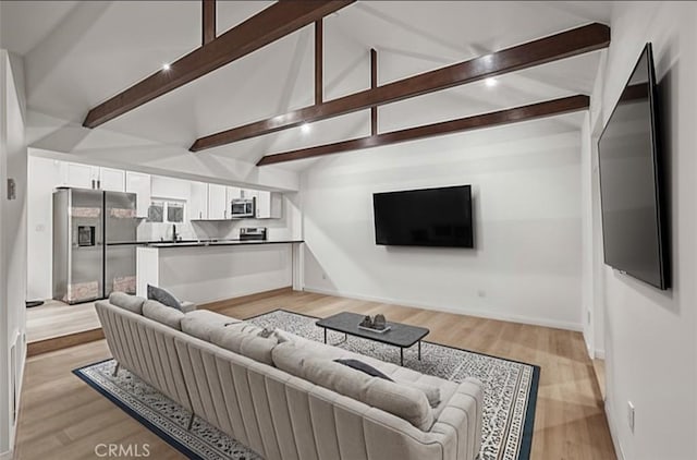 23817 Crest Forest Dr, Crestline, CA 92325 - living room with baseboards, lofted ceiling with beams, and light wood-style flooring