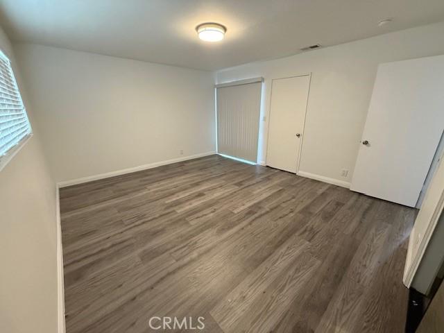 13305 Cordary Ave, Hawthorne, CA 90250 - unfurnished bedroom with wood finished floors and multiple closets