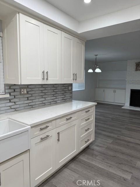 13305 Cordary Ave, Hawthorne, CA 90250 - kitchen featuring white cabinets, decorative backsplash, wood finished floors, open floor plan, and recessed lighting