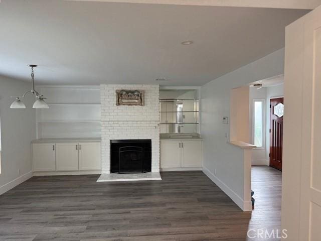 13305 Cordary Ave, Hawthorne, CA 90250 - unfurnished living room featuring dark wood-style flooring and a brick fireplace