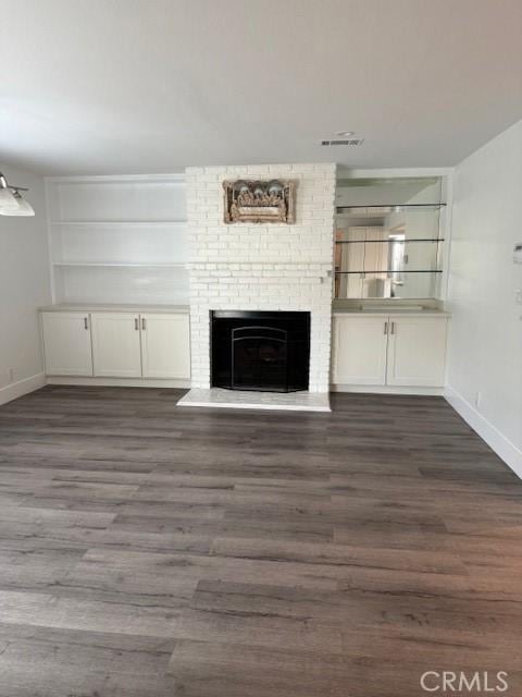13305 Cordary Ave, Hawthorne, CA 90250 - unfurnished living room with dark wood-style flooring and a fireplace
