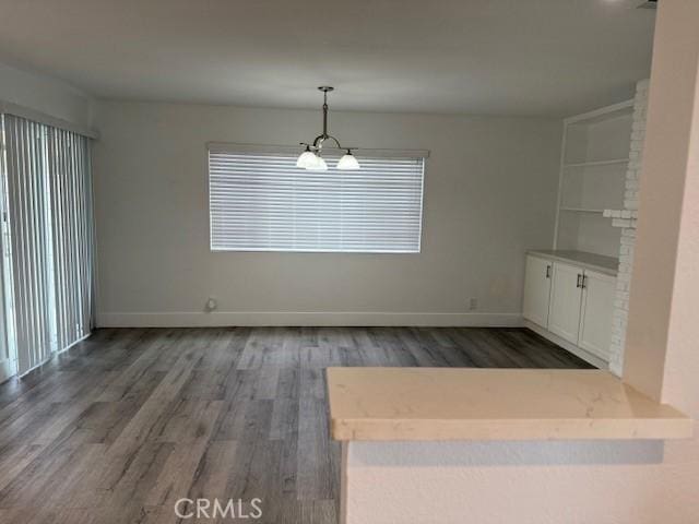 13305 Cordary Ave, Hawthorne, CA 90250 - unfurnished dining area featuring wood finished floors and baseboards