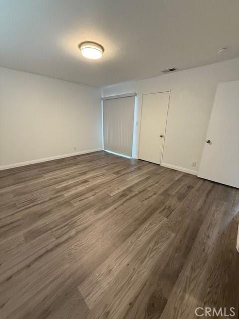 13305 Cordary Ave, Hawthorne, CA 90250 - unfurnished bedroom featuring dark wood finished floors and baseboards