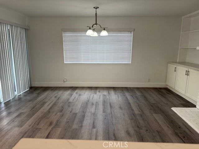13305 Cordary Ave, Hawthorne, CA 90250 - unfurnished dining area featuring dark wood-style flooring and a chandelier