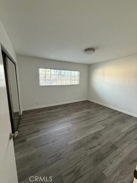 13305 Cordary Ave, Hawthorne, CA 90250 - unfurnished bedroom with dark wood-type flooring and baseboards