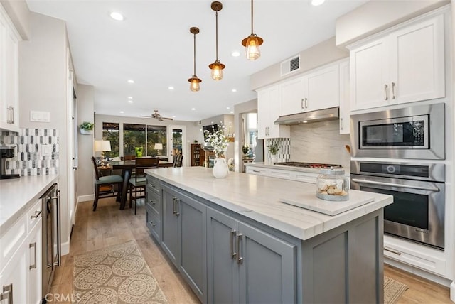 5 Creek View Rd, Coto De Caza, CA 92679 - kitchen with appliances with stainless steel finishes, gray cabinets, white cabinetry, backsplash, and under cabinet range hood