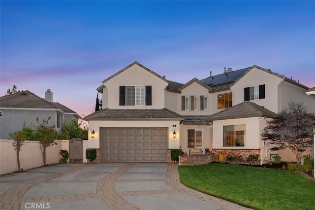 5 Creek View Rd, Coto De Caza, CA 92679 - view of front facade featuring a yard, a garage, roof mounted solar panels, concrete driveway, and stucco siding